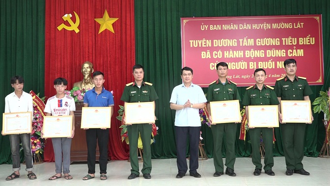 Đồng chí Triệu Minh Xiết, Phó Bí thư Thường trực Huyện uỷ trao giấy khen của Chủ tịch UBND huyện cho các cá nhân tiêu biểu có hành động dũng cảm trong vụ cứu sống nữ sinh V.T.D.